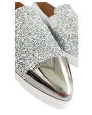 Close-up of Miu Miu pointed toe sneakers showing silver metal toe cap and sparkle detail