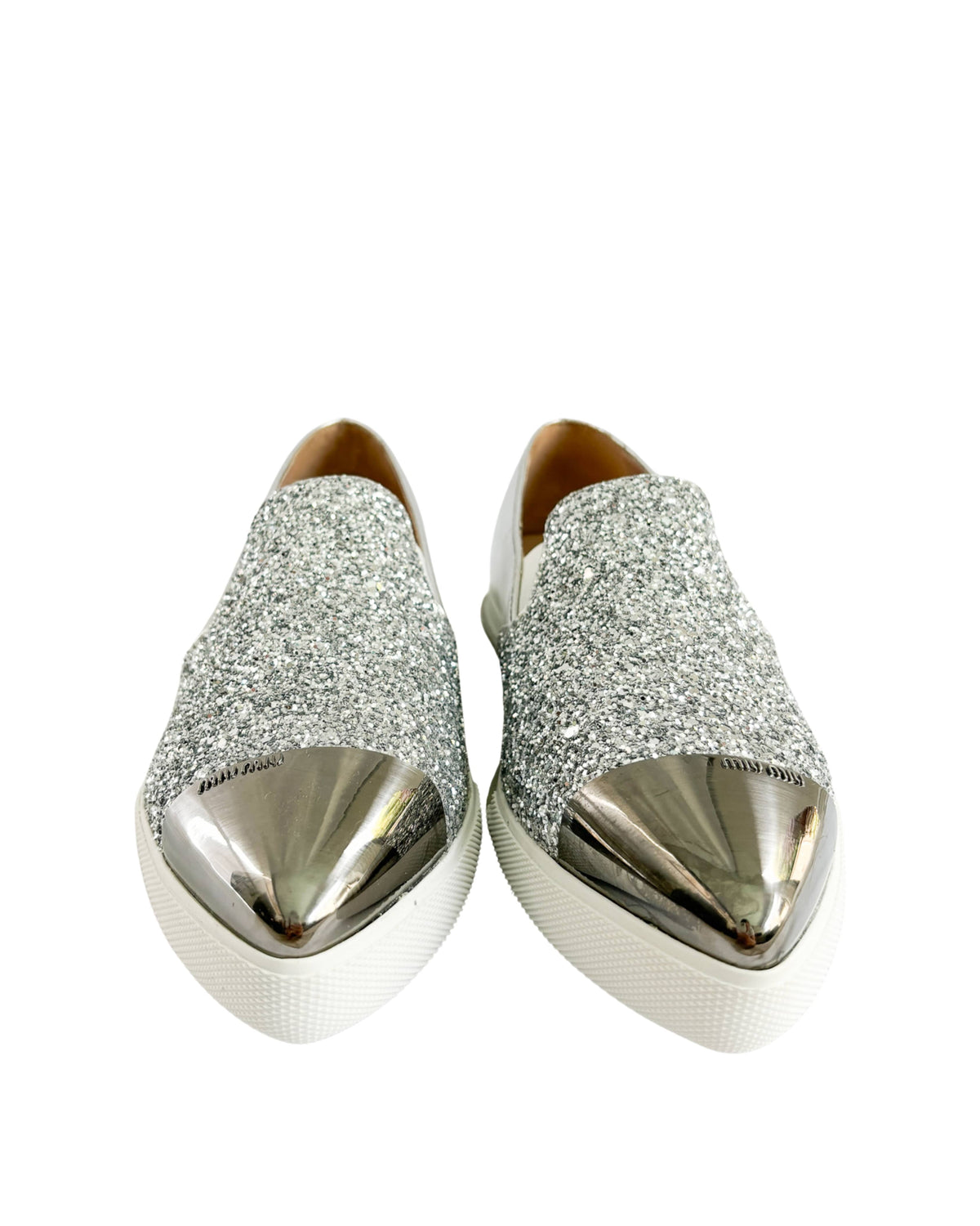 Front view of Miu Miu pointed toe sneakers showing silver metal toe cap and sparkle detail