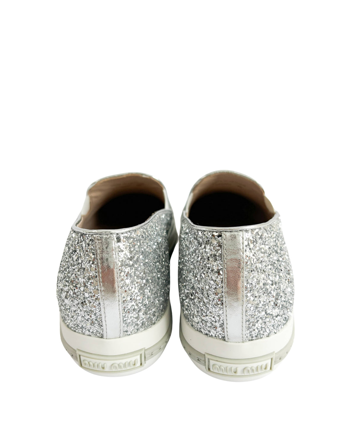 Back view of Miu Miu round toe slip-on sneakers with silver glitter finish