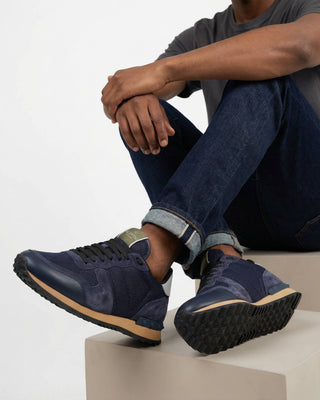 Close-up of signature stud detail on the heel of Valentino Rockrunner trainers in Night and Marine