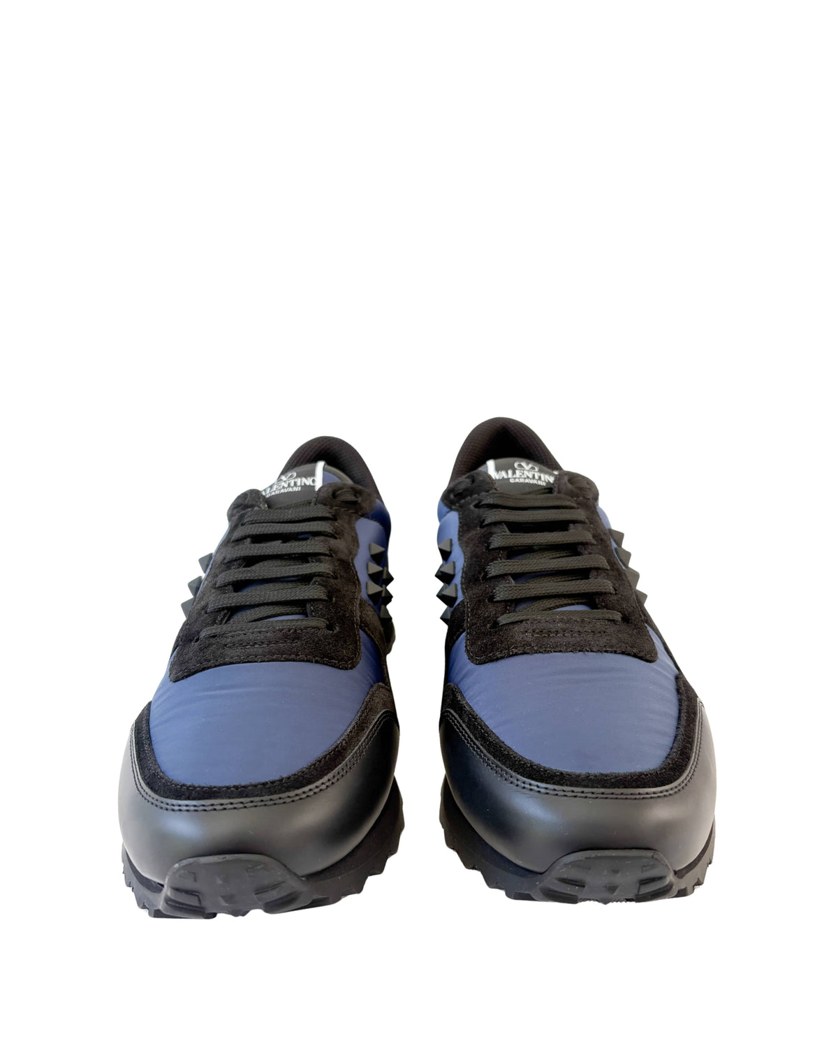 Front view of a pair of navy blue Valentino Rockrunner sneakers displaying black toe caps and laces.