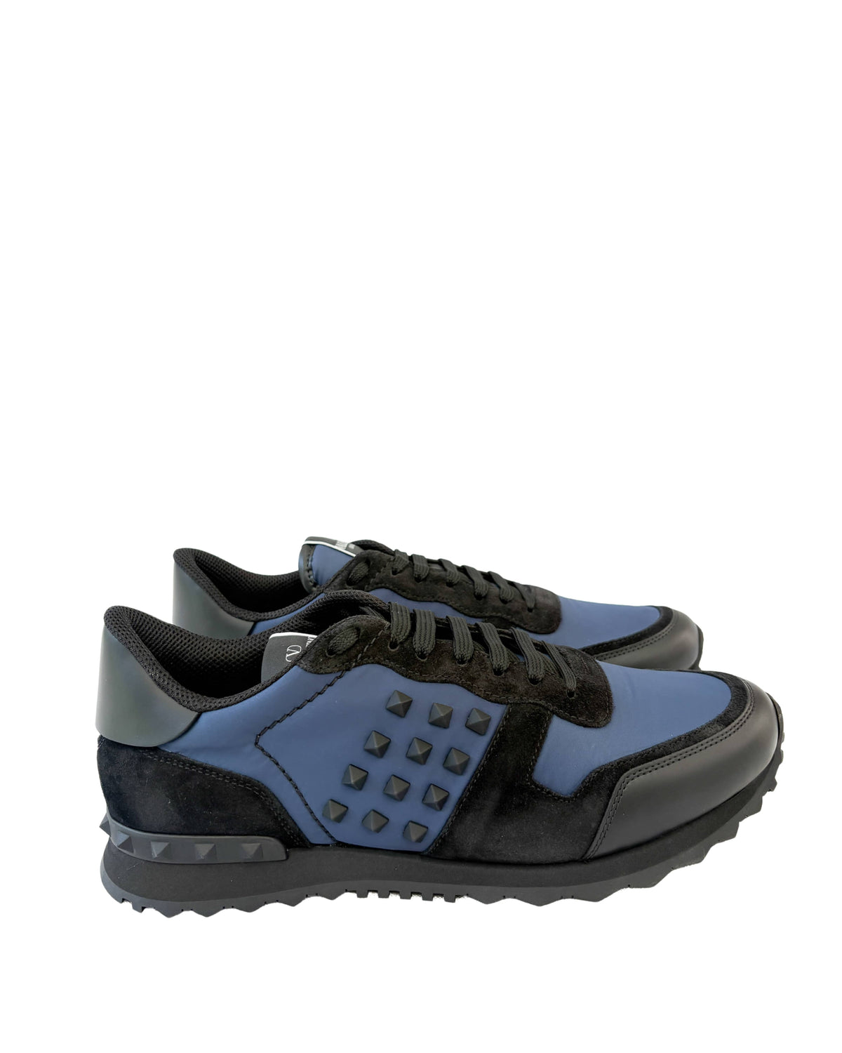 Side profile view of Valentino Rockrunner navy blue designer trainer showing treaded rubber sole.