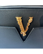 Close-up of Versace Virtus camera bag showing signature V emblem