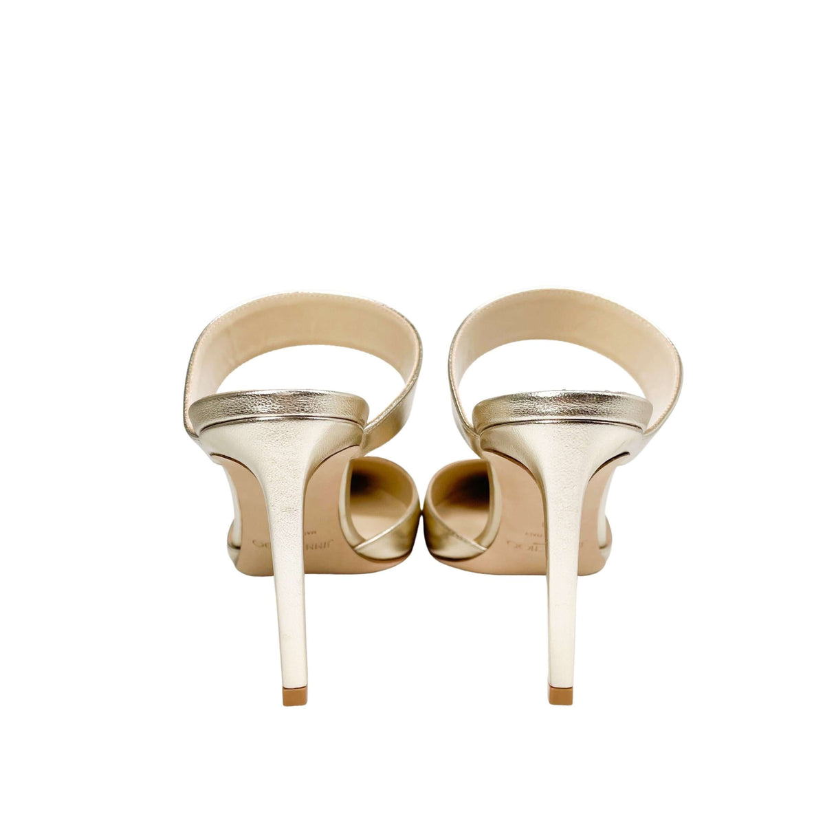 Rear view of Jimmy Choo Cheri 85 metallic gold heels displaying the back heel counters and wide ankle strap closure.