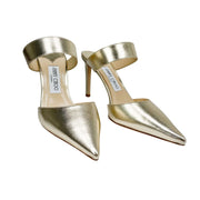 Angled studio shot of Jimmy Choo Cheri 85 gold luxury dress shoes showcasing the ankle strap and stiletto heels.